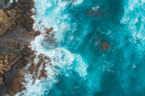 Aerial view of waves splashing on beach. stock photo