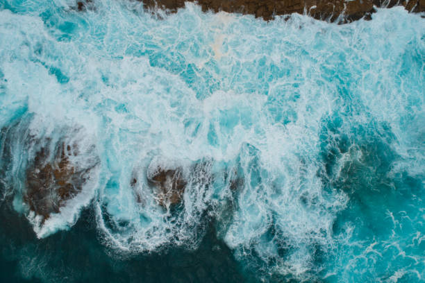 istock Aerial view of waves splashing on beach. 1139797982