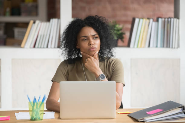 istock Thoughtful doubtful african worker feeling puzzled at work with laptop 1139798856
