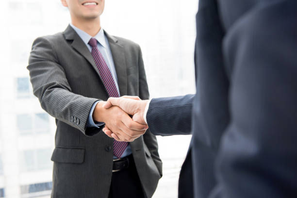 istock Business partners making handshake - greeting, dealing, merger and acquisition concepts 1139798911