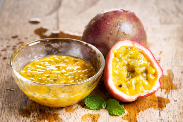 istock Ripe passion fruit and passion fruit juice on wooden background 1139799220