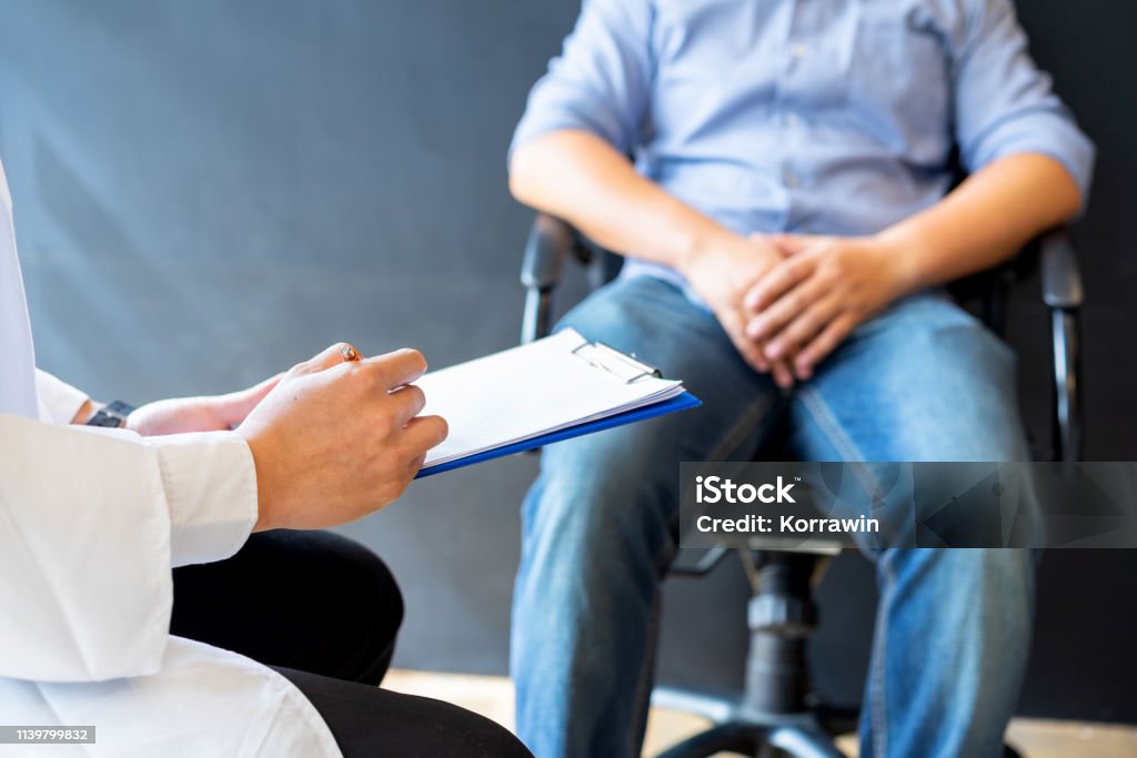 Male doctor and prostate cancer patient are discussing about prostate cancer test report. Diagnostic, prevention of men diseases, healthcare, medical service, consultation, healthy lifestyle concept. Prostate Gland Stock Photo