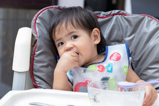istock Close up baby eating meal by herself. 1139802138