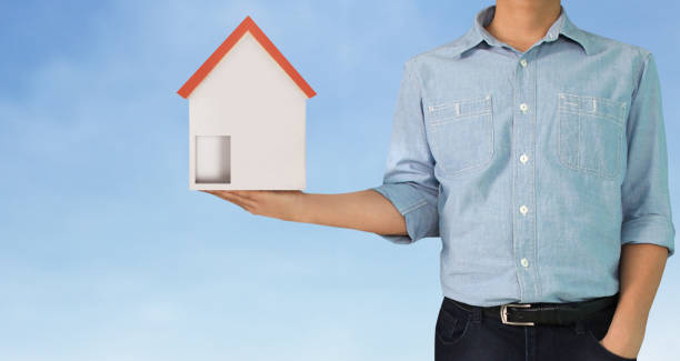 istock Mortgage concept by house from hand 1139803097