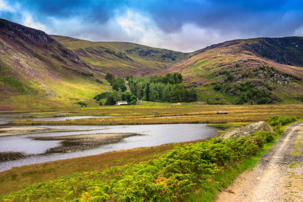 Hiking trail in Angus, Scotland, UK. Path around Loch Lee in Cairngorms National Park, south of the Grampian Mountains.