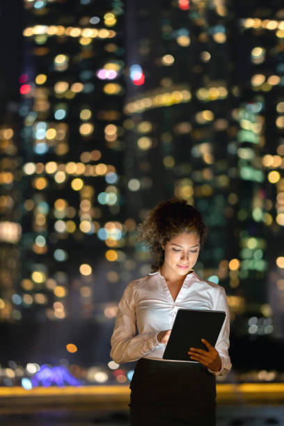 istock Business woman working at night using app on a tablet computer 1139805747