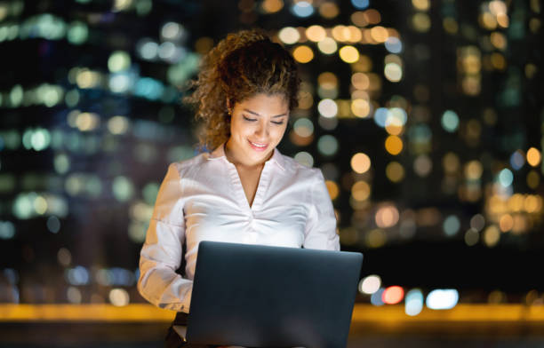 istock Business woman working at night using a laptop computer 1139805751
