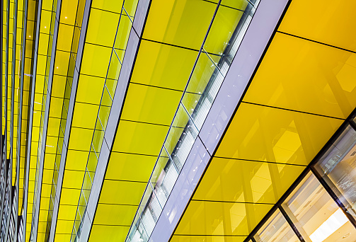 Abstract shot of layers of Yellow Glass. Taken on public property in Angel Lane, London