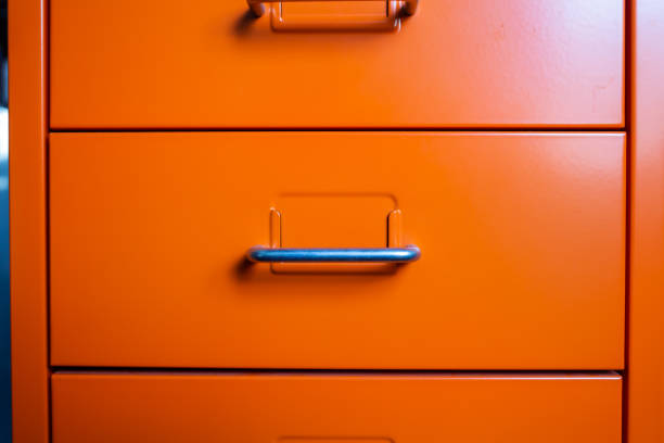 Filing cabinet with closed drawer, Orange silver metal colour, Administration and storage concept