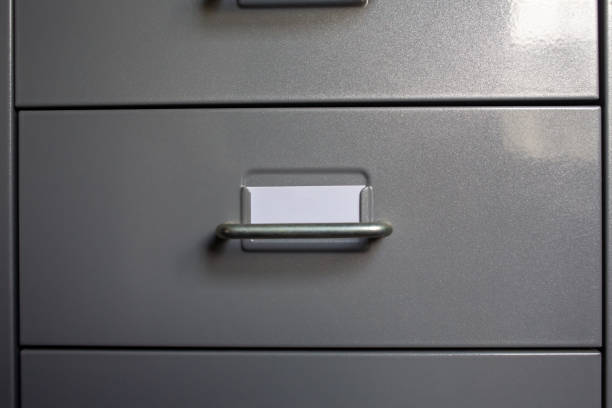 istock Filing cabinet with closed drawer, A white card for write letter, Grey silver metal colour, Administration and storage concept, closeup & Macro shot 1139814995