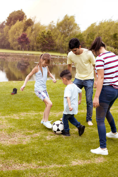 istock Family group playing soccer 1139814996
