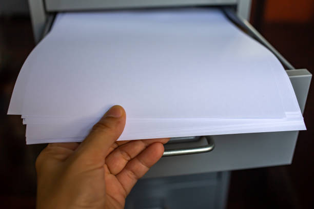 istock Woman's hand pick up white papers for write letter, Filing cabinet with open drawer, Grey silver metal colour, Administration and storage concept, closeup & Macro shot, Selective focus 1139815029