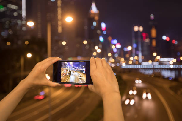 istock Hands using smartphone taking photo at night in Hong Kong 1139816931