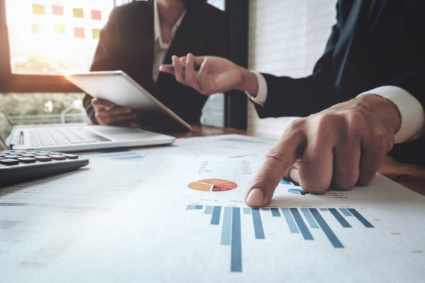istock Economic research discussions, Business team analyzing income charts and graphs to plan marketing concept with using tablet and calculator  for analysis. 1139817566