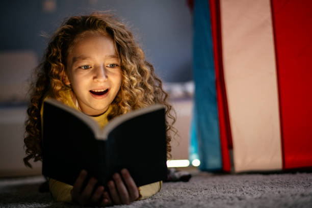 istock Cute Girl Reading a Book at Home 1139821364