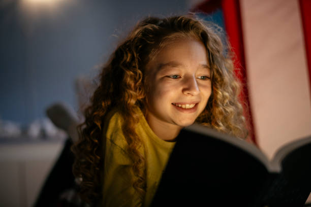 istock Cute Girl Reading a Book at Home 1139822621