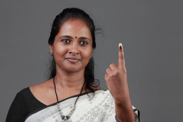 istock Woman shows her finger marked with ink after casting vote 1139823185