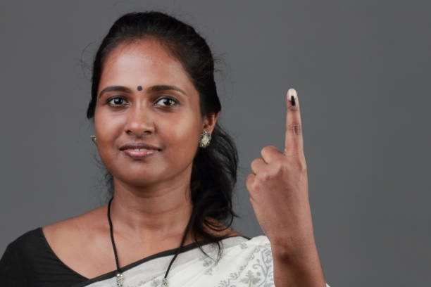 istock Woman shows her finger marked with ink after casting vote 1139823192