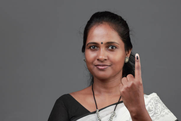 istock Woman shows her finger marked with ink after casting vote 1139823228