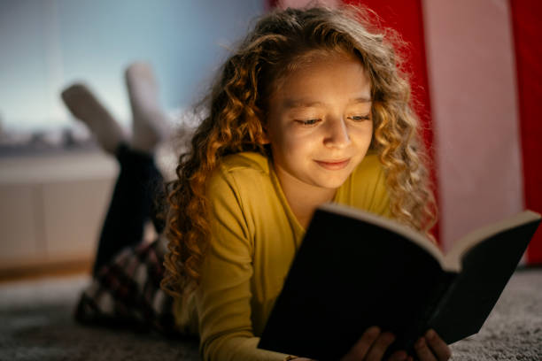 istock Cute Girl Reading a Book at Home 1139823290