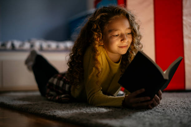 istock Cute Girl Reading a Book at Home 1139823322