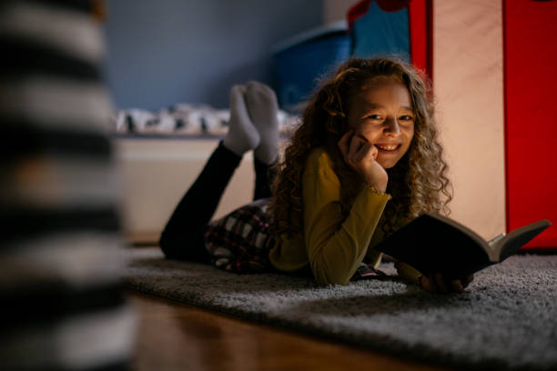 istock Cute Girl Reading a Book at Home 1139823378