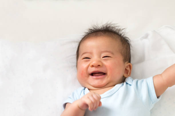 istock Happy little Asian baby smiling while lying on white bed 1139823606