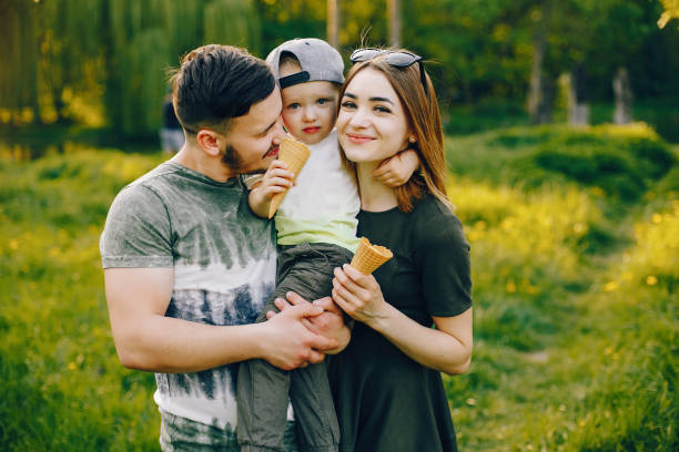 istock Cute family in a park 1139824192