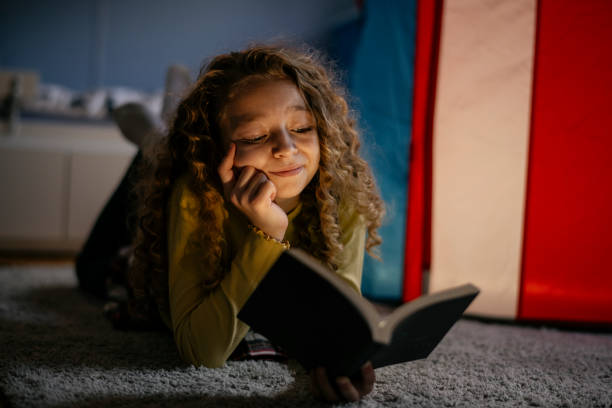 istock Cute Girl Reading a Book at Home 1139824485