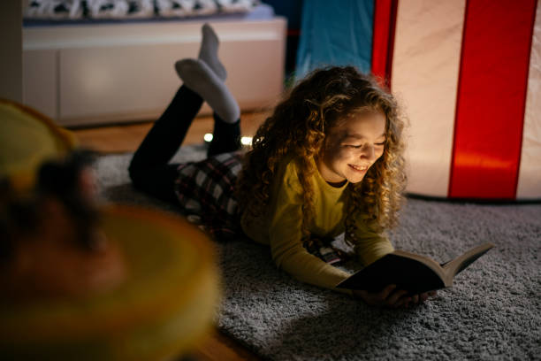 istock Cute Girl Reading a Book at Home 1139824578