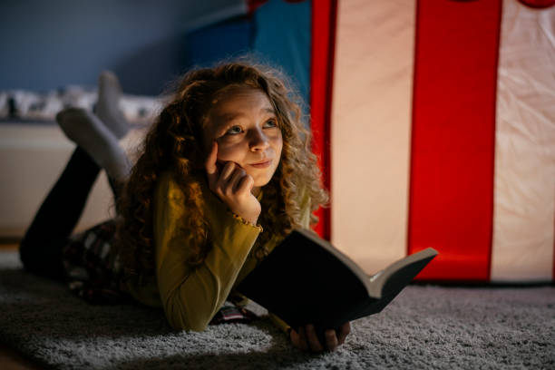 istock Cute Girl Reading a Book at Home 1139824955