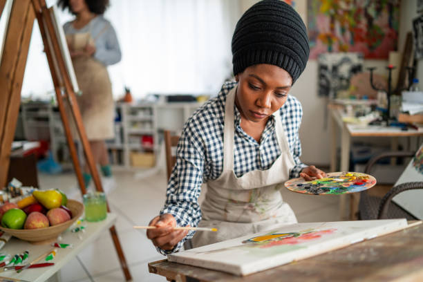 istock Young afro woman drawing 1139826855