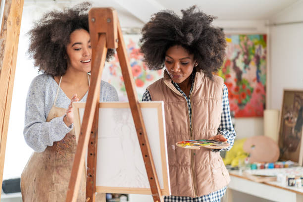 istock Afro Female fine artists drawing in studio 1139826859