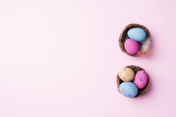 istock Colorful easter egg in the nest on pink background with copy space. Easter background. Minimalism 1139828753