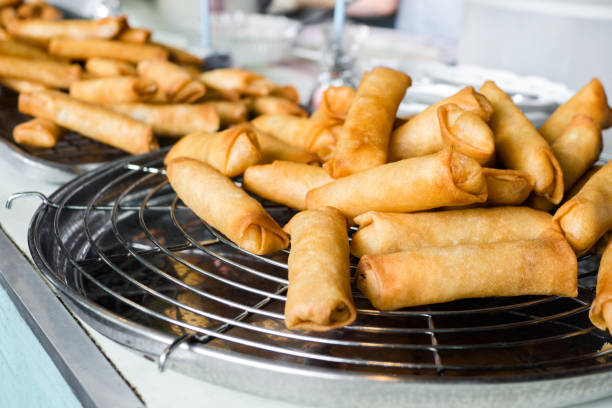 istock Thai food, Fried spring rolls on black iron plate on grey stone slate background. Top view and copy space. 1139828958