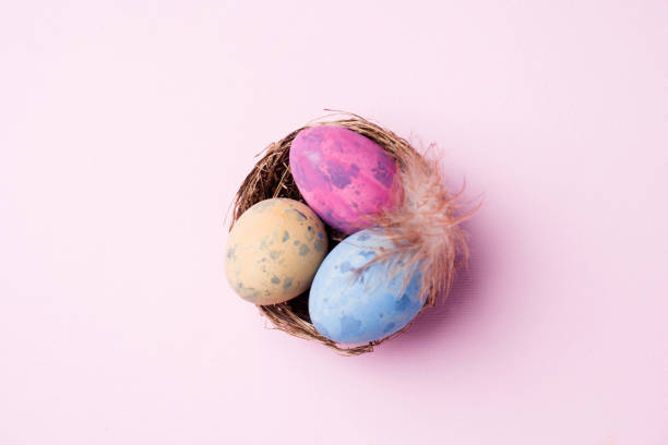 istock Colorful easter egg in the nest on pink background with copy space. Easter background. Minimalism 1139829028