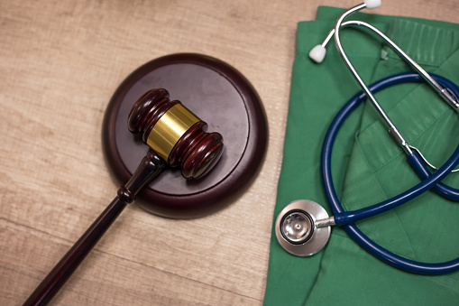 Gavel and stethoscope in background. Medical laws and legal concept.