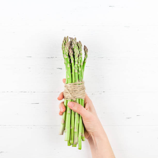 istock Fresh green asparagus in woman hands 1139838586