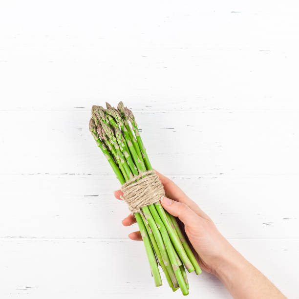 istock Fresh green asparagus in woman hands 1139838596