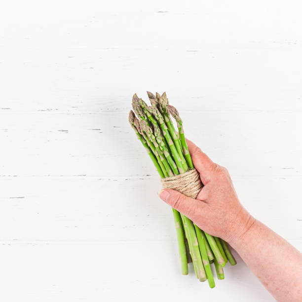 istock Fresh green asparagus in woman hands 1139838603