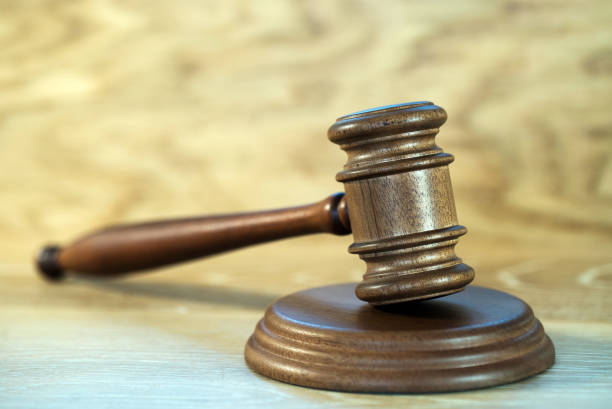istock Law and justice concept image. Brown wooden background 1139838995
