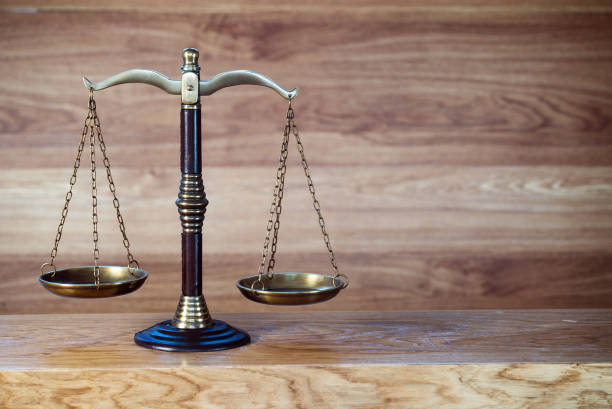 istock Law and justice concept image. Brown wooden background 1139841192