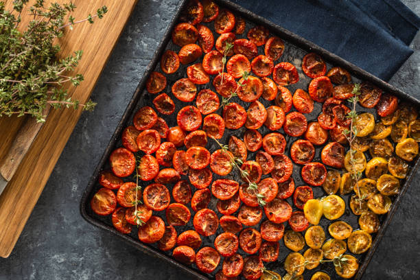 istock Baked cherry tomatoes in baking tray top view 1139841238