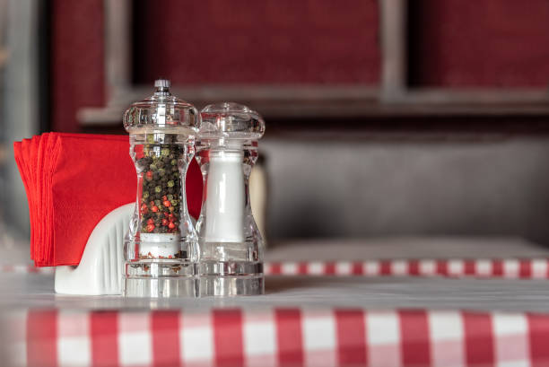 Salt, pepper, a wood table and copy space