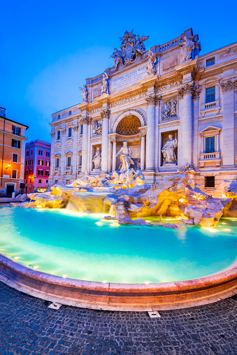 Rome, Italy. Stunningly ornate Trevi Fountain illuminated at night in the heart of baroque Roma.