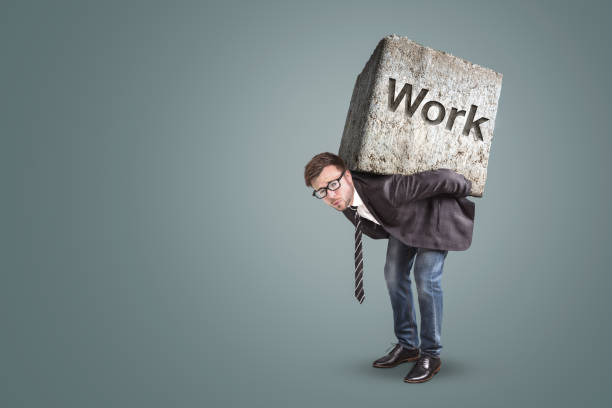 istock Businessman bending under a heavy stone with the word 