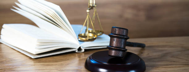 istock Law and justice concept image. Brown wooden background 1139845210
