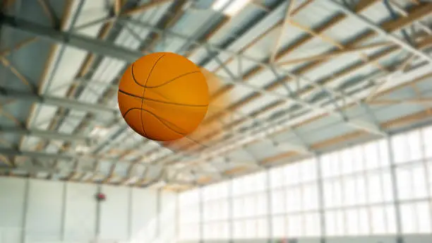 Basketball freeze-frame with speed blur effect inside a gymnasium
