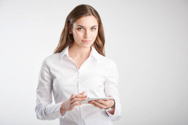 istock Young woman holding touchpad in her hand 1139847225