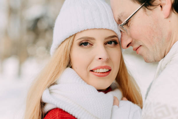 istock Young man with bag hugs his girlfriend in winter forest 1139847397